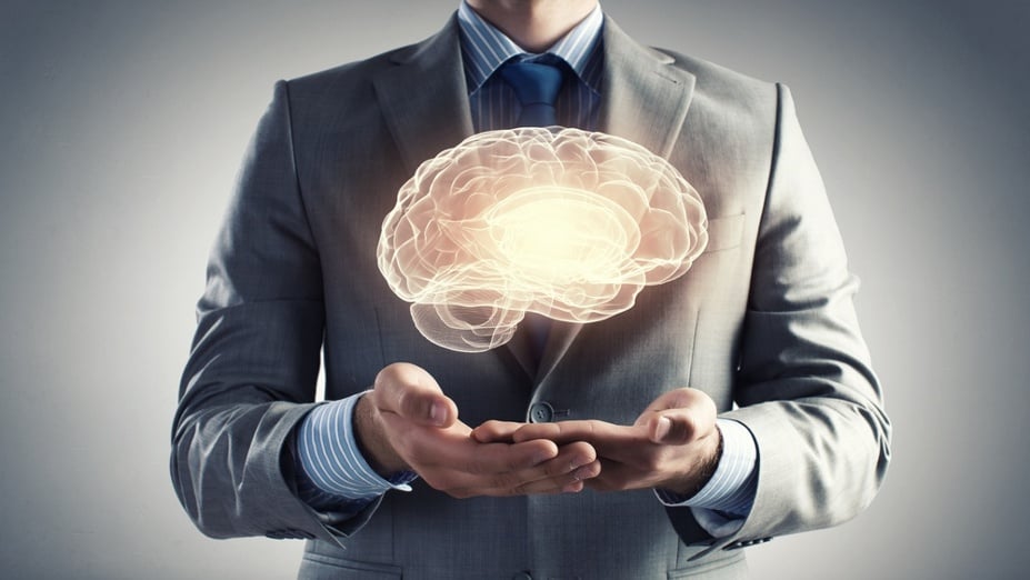Close up of businessman holding digital image of brain in palm.jpeg