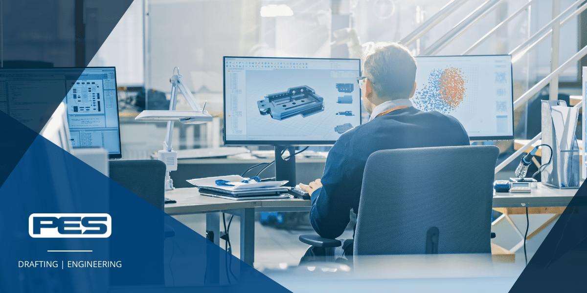 Design drafter sitting at desk with two monitors showing design drafting software at PES